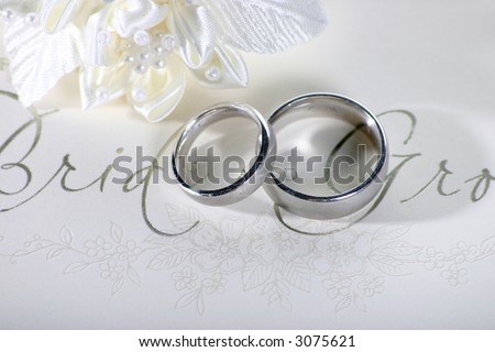 stock photo Silver wedding rings on a card saying Bride and Groom