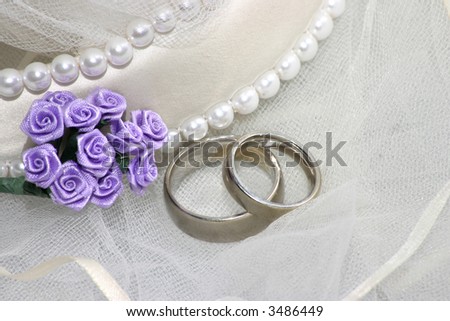 stock photo wedding bands with veil and decorative purple flowers