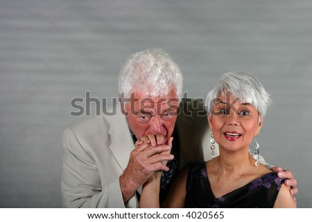 Portrait of mature couple husband kissing the hand of his wife