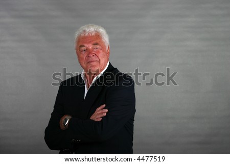 mature man well-dressed looking determined
