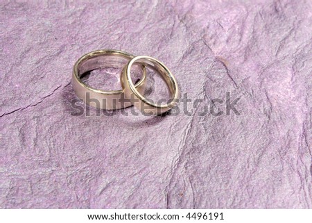 stock photo wedding bands on lavender silvery background