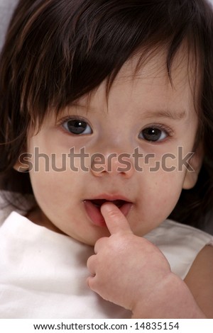 Cute baby girl with finger in her mouth