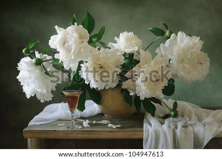 Still life with white peonies and a glass of wine
