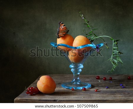 Still life with apricots in a blue bowl