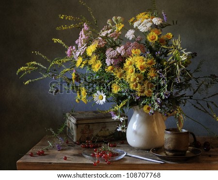 Still life with a bouquet of filed flowers and a cup of tea