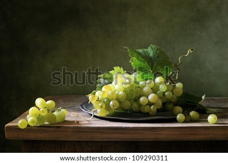 Still life with a bunch of green grapes