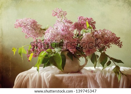Still life with a bouquet of blooming lilacs