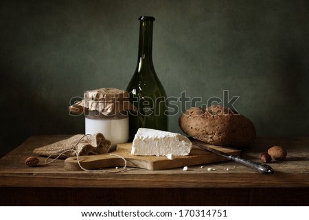 Still life with cheese, bread and milk