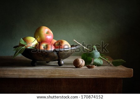 Still life with apples and a walnut