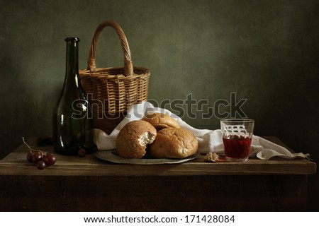 Still life with fresh bread and a glass of red wine