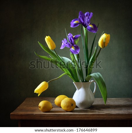 Still life with yellow tulips, irises and lemons