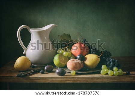Classical still life with fruit and a white jar