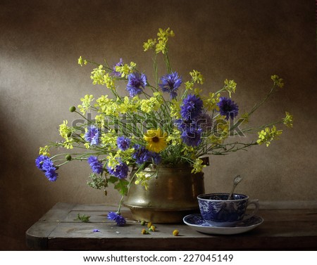 Still life with wild flowers and a cup of tea