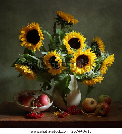 Still life with sunflowers and apples