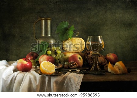 Classical still life with fruit, cheese, nuts and wine