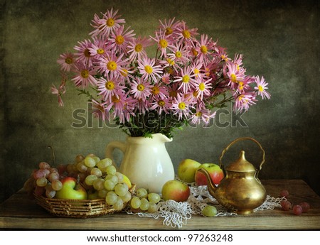 Still life with a beautiful bouquet and juicy fruit