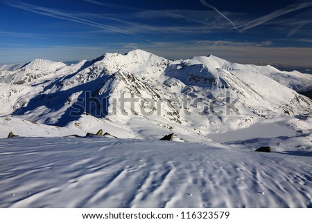 Summits and slopes covered by snow in Retezat mountains, Romania
