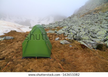 Green tent on the mountain in spring