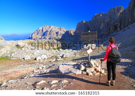 Mountaineer near mountain crossroads, Dolomite Alps, Italy