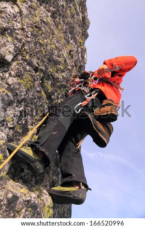 Climbing team leader searching the rack for a protection piece