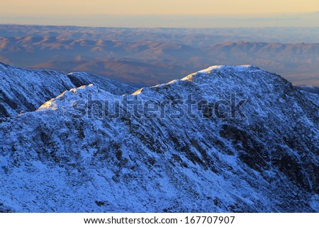 Snow covered ridges lit by the sunset light