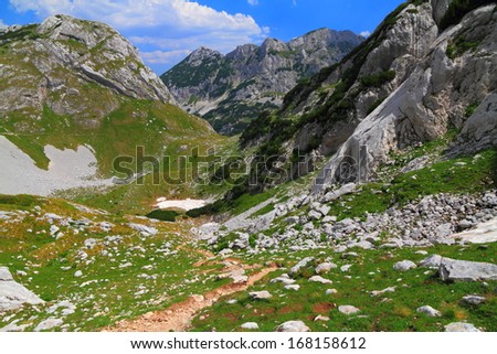Winding mountain trail, climbing the mountain in sunny day