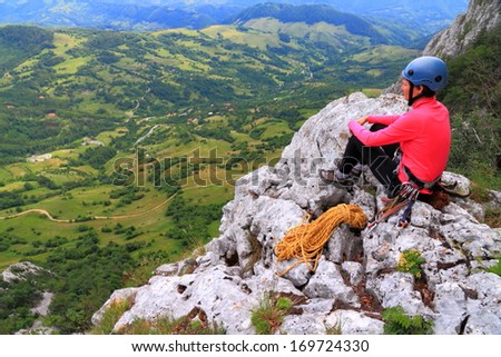 Mountaineer watching the scenery on top of the mountain