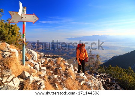 Woman climbs the mountain summit