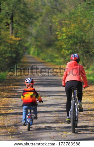Family Bike Ride In Autumn Forest