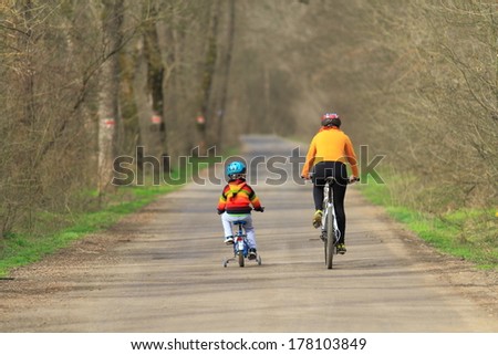 Family Riding Bikes On Forest Road