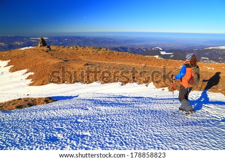 Mountaineer traverses white snow field on the mountain in summit