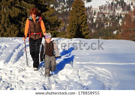 Outdoor walk of a mother and son in winter time