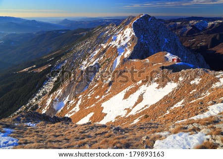 Remote mountain ridge with snow sport at sunrise