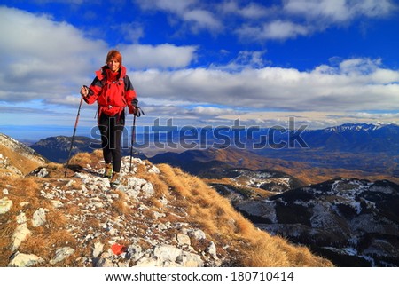 Young hiker steps on the rocky trail on top of the mountain