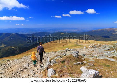 Sunny day and a relaxing trip on the mountain for mother and boy