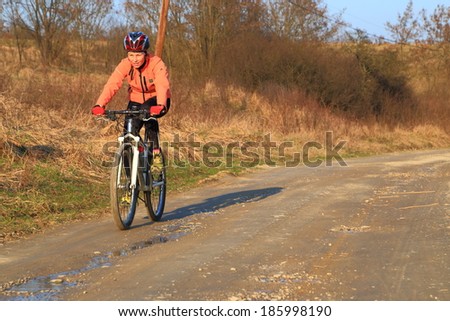 Woman during bike trip in sunny spring day