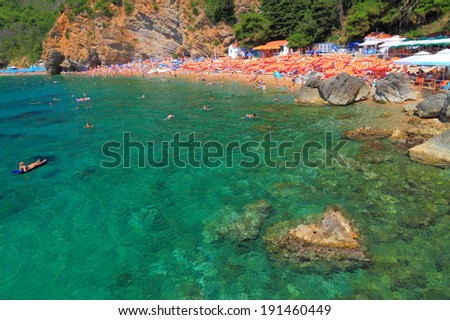 Sunny beach and green waters of the Adriatic sea