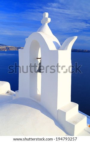 White bell tower of traditional church on the Santorini island, Greece