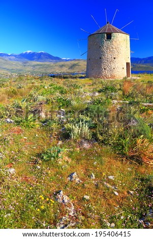 Traditional wind mill on the sunny hills of Greece