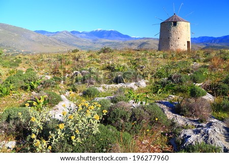 Stone building of a Greek wind mill located on the sunny hills of Greece
