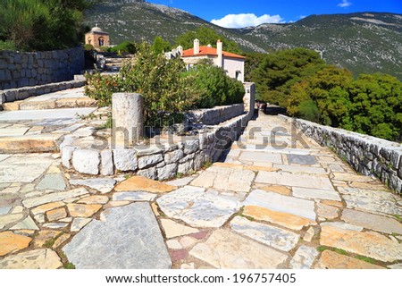 Stone paved walkway descending to byzantine monastery, Greece
