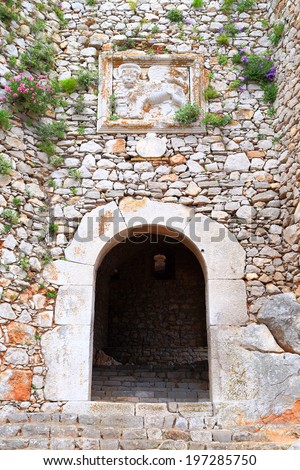 Open gate and Venetian lion with wings at the fortress of Palamidi, Nafplio, Greece