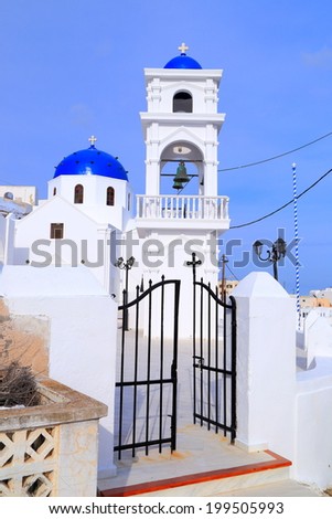 Open gate to traditional white church on the island of Santorini, Greece