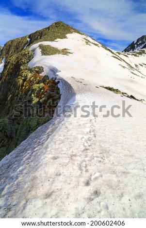 Mountain summit covered with snow patches in springtime