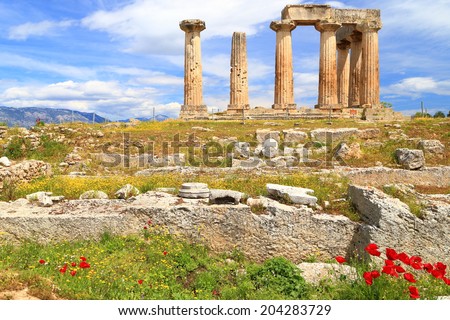 Spring flowers around the temple of Apollo in sunny day, Ancient Corinth, Greece