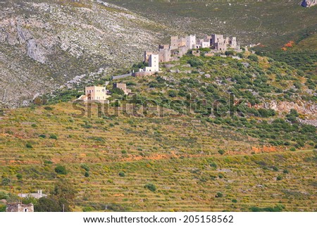 Isolated village on a Greek hill with tower shaped houses, Vatheia, Greece