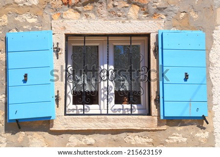 Vintage window with wood shutters wide open on sunny street of Mediterranean town, Rovinj, Croatia
