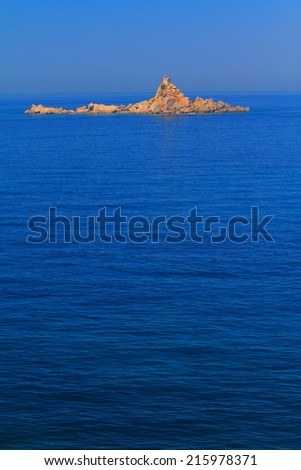 Small stone church on remote island surrounded by Mediterranean sea