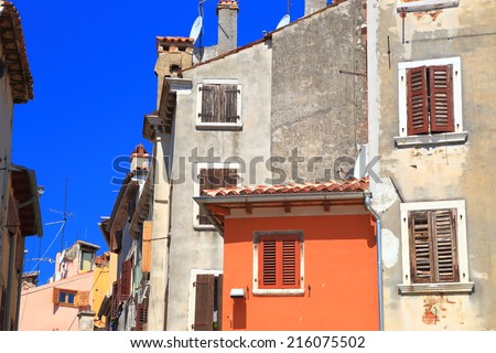 Windows with closed wood shutters on the walls inside Venetian town of Rovinj, Croatia