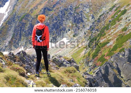 Woman on aerial mountain trail in sunny day